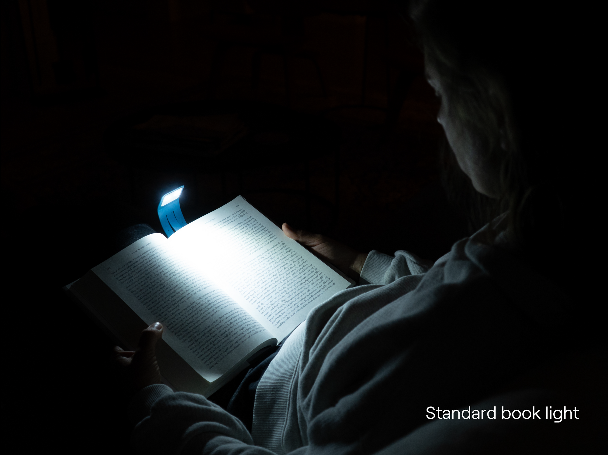A typical book light spilling cool glare across the page
