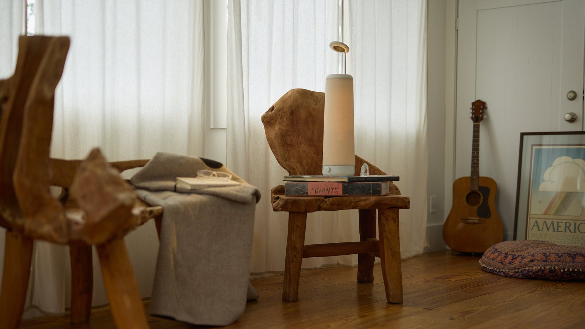 NS01 lamp on a wooden chair beside a sunlit window